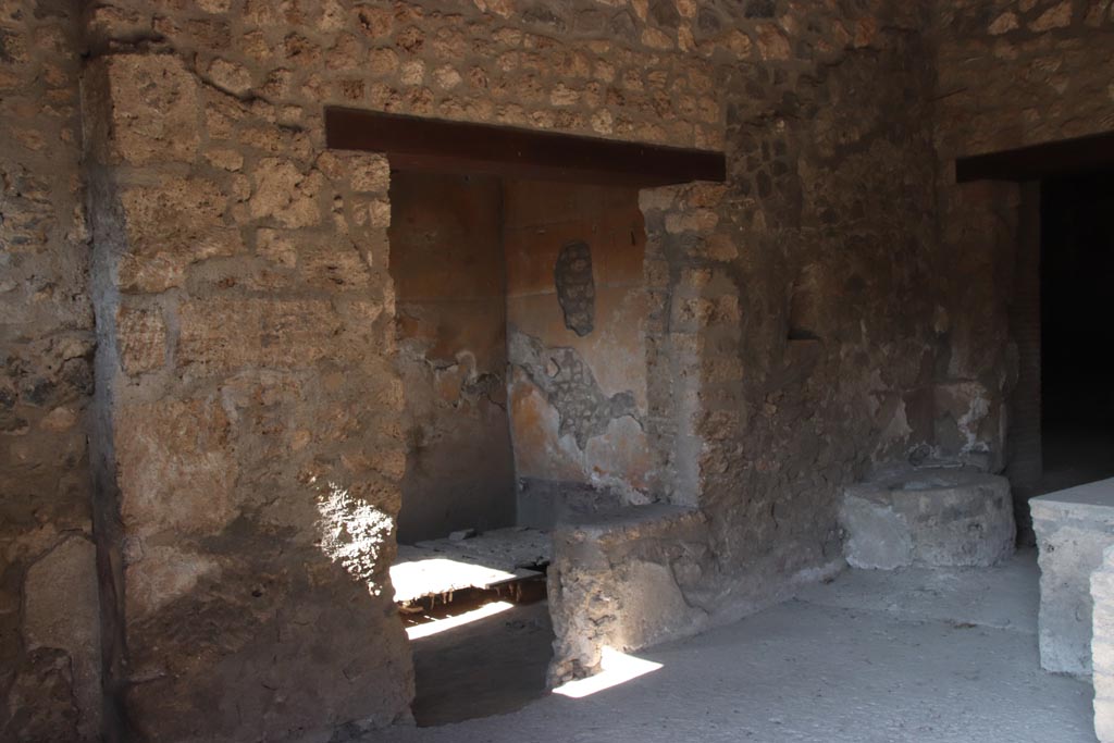I.14.15 Pompeii. October 2022. 
Looking towards west side of bar-room with doorways to room on west side, in centre. Photo courtesy of Klaus Heese.

