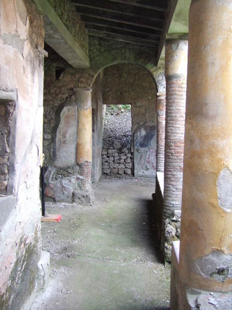 I.17.4 Pompeii.  May 2006. Looking west along south portico.  
At the far end can be seen the site of a staircase (now filled in again).
