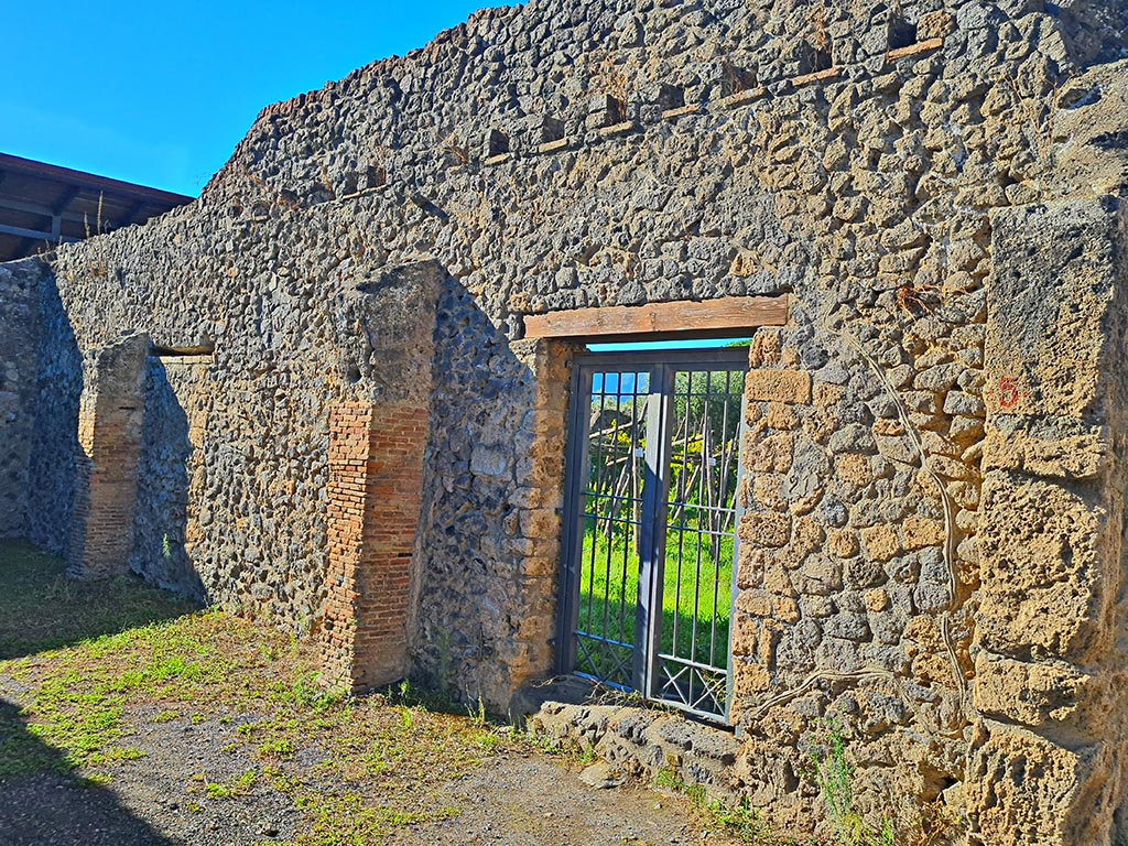 I.20.5 Pompeii. October 2024. Entrance doorway to vineyard/garden in west wall. Photo courtesy of Giuseppe Ciaramella.