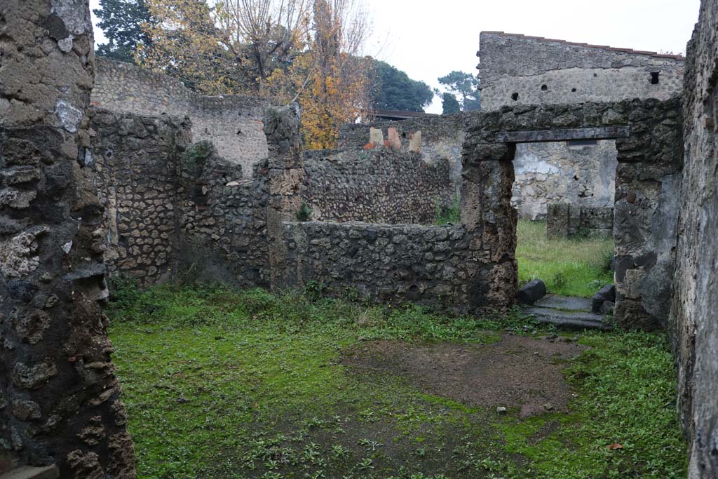 II.1.13 Pompeii. December 2018. 
Looking south-east from entrance into large room (?dining room) with window and doorway to garden area. Photo courtesy of Aude Durand.

