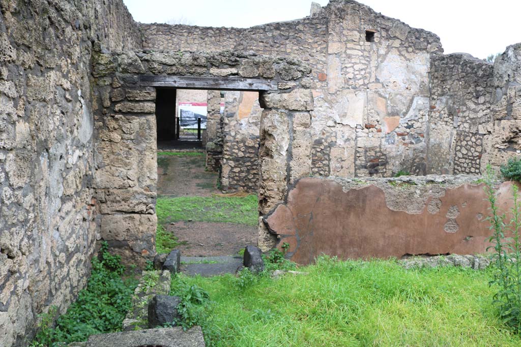 II.1.1/13 Pompeii. December 2018. 
Looking towards north-west corner with doorway into large dining room and through to front of bar-room. Photo courtesy of Aude Durand.
