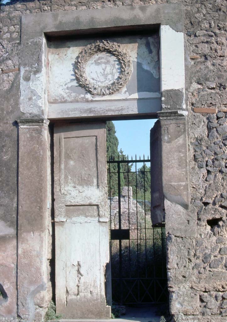 II.2.4 Pompeii. May 2016. Emblem decoration above entrance doorway. Photo courtesy of Buzz Ferebee.
