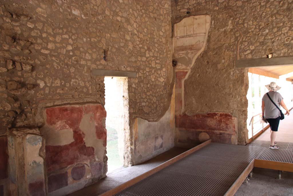 II.4.3 Pompeii. September 2019. South-east corner of atrium, with doorway to II.4.4, centre left, and doorway to west portico, on right.
Photo courtesy of Klaus Heese. 
