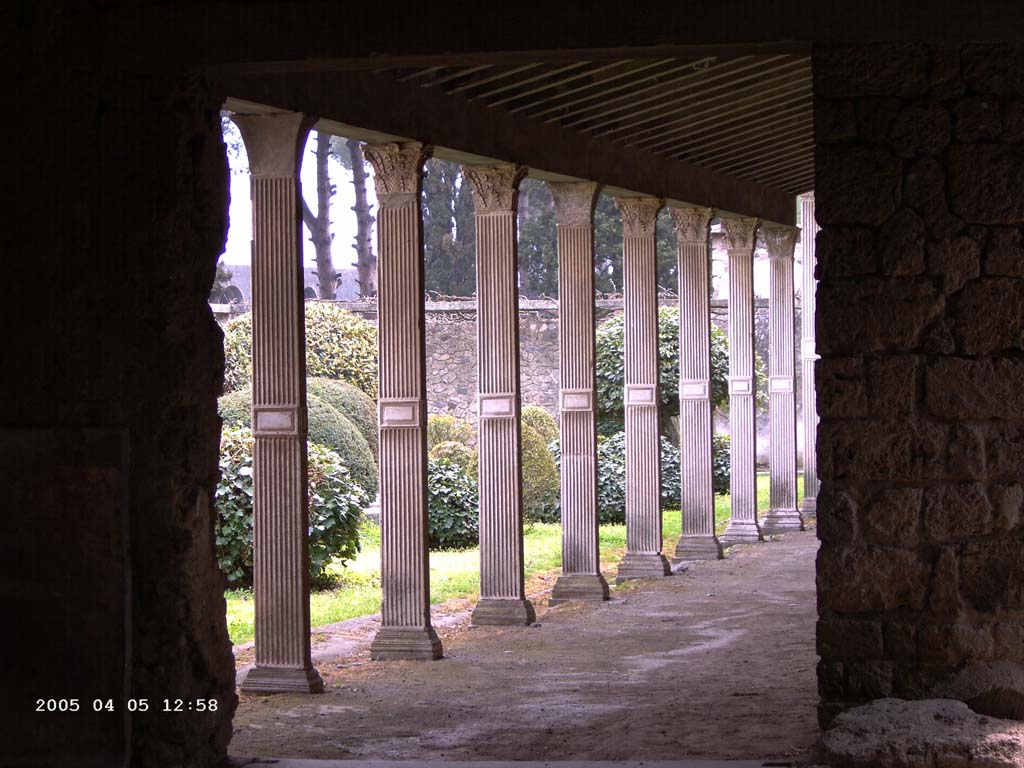 II.4.3 Pompeii. April 2005. Looking south from doorway in south-east corner of atrium, along west portico (of II.4.6).
Photo courtesy of Klaus Heese.

