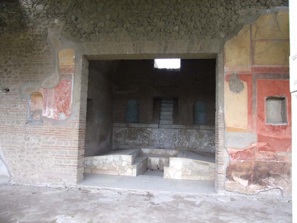 II.4.6 Pompeii. December 2006. Summer triclinium with cascade fountain, looking west from portico.
The niche on the left of the doorway was described as in ambiente 85.
In May 1755, near 85 a small niche in the wall of the portico, 47 fragments of terracotta were found in the ash, relating to two figures.
When restored, they showed la Carita Romana, the roman charity.
Now in Naples Archaeological Museum, inventory number 22580.
See Pagano, M. and Prisciandaro, R., 2006. Studio sulle provenienze degli oggetti rinvenuti negli scavi borbonici del regno di Napoli. Naples: Nicola Longobardi. 
(Vol.1, p.16 dated 1st June 1755, and Vol.2, p.341, fig.93 in Rami inediti)
