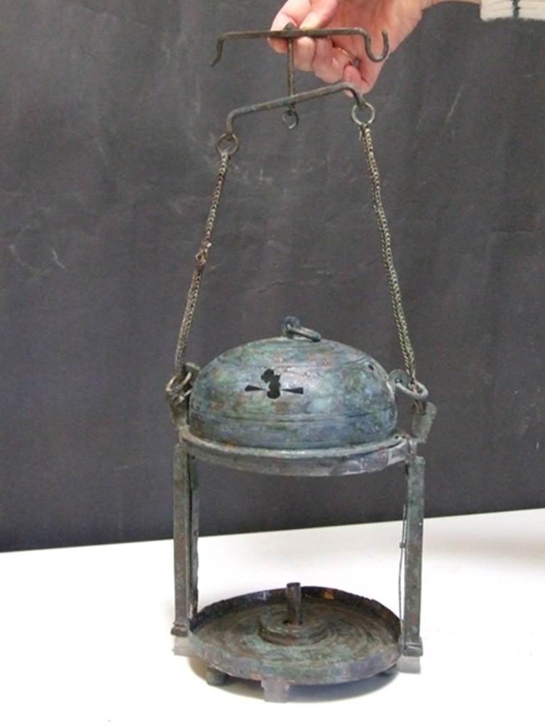 II.4.8 Pompeii. Found in 1934. Small room or stall to south of entrance. Bronze lantern. SAP inventory number 5798. The inventory card says it was found in the first room west side, vicolo crossing Via Abbondanza. Primo vano lato O. vicolo trasversale V. Abbondanza. According to Parslow, In a small room near this entrance [II.4.8] the excavators came across two large bronze lanterns which originally may have been suspended by their chains from the ceiling joists, since they were found near the level of the roof. He also identifies these with SAP inventory numbers 5798 and 5816. See Parslow, C., 1988. Rivista di studi pompeiani II. Roma: LErma di Bretschneider. (pp. 37).