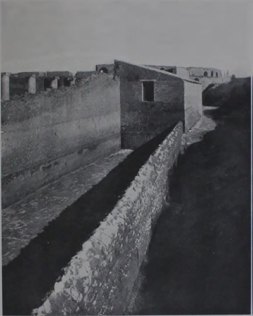 II.7.1/II.7.11 Pompeii. “La forica della Palestra”. 
Looking east along south side towards the amphitheatre.
See Notizie degli Scavi, 1939, p. 191, fig.16.
