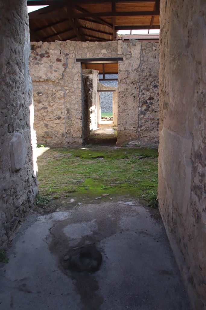 II.8.6 Pompeii. October 2022. 
Looking east across entrance corridor/vestibule flooring towards door-stop. Photo courtesy of Klaus Heese.
