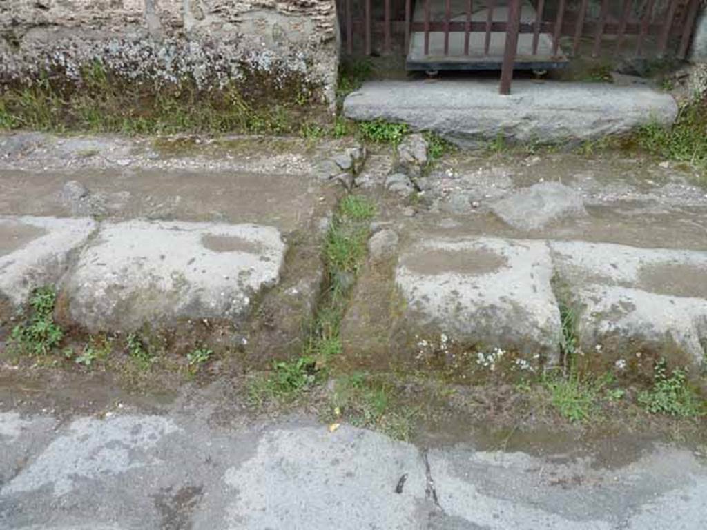 II.9.2 Pompeii. May 2010. Drainage in pavement of Via di Nocera, outside entrance doorway.