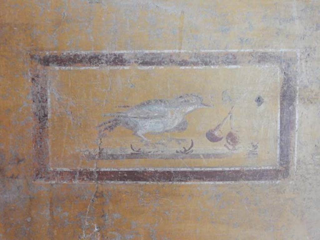 II.9.4, Pompeii. May 2018. Room 8, painted panel with bird and cherries from west wall at south end.
Photo courtesy of Buzz Ferebee.  

