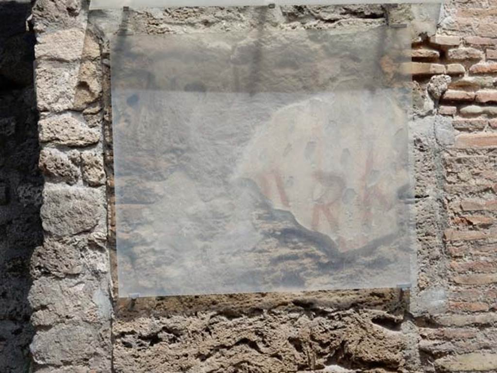 III.1.1 Pompeii. May 2018. Pilaster between III.1.1 and III.1.2, with the remains of painted graffiti. Photo courtesy of Buzz Ferebee.