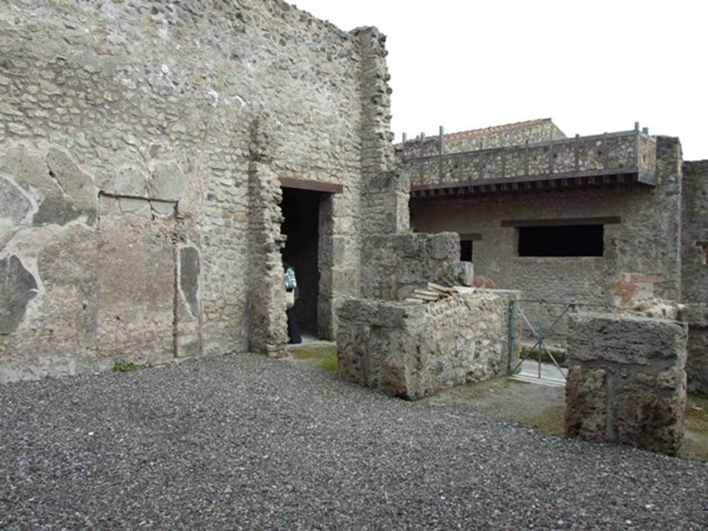 III.2.1 Pompeii. March 2009. Room 1, atrium. Looking south-east across atrium to entrance fauces and doorways to rooms 6 and 7.
On the left is the blocked-up doorway that would originally have led into room 7.
.