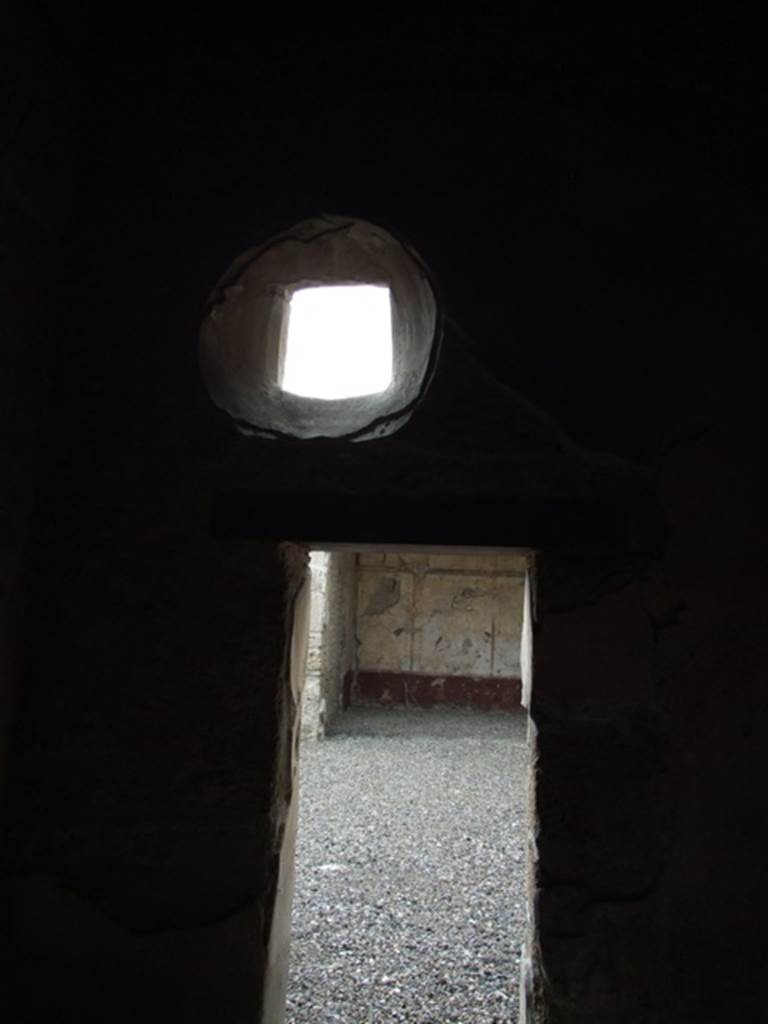 III.2.1 Pompeii. March 2009. Room 8, doorway and circular window in west wall of cubiculum.
