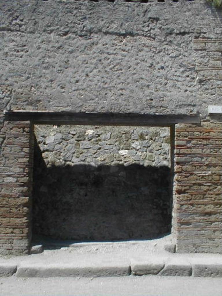 III.2.3 Pompeii. May 2005. Entrance doorway, partly excavated.
According to Varone and Stefani, found on the right pilaster was –
L(ucium)  Ceium  IIvir(um)  i(ure)  d(icundo)     [CIL IV 9931a]
This is no longer visible, but a small amount of white on the brickwork marks the spot. See Varone, A. and Stefani, G., 2009. Titulorum Pictorum Pompeianorum, Rome: L’erma di Bretschneider, (p.241)
According to Della Corte, to the right of the entrance was found –
Priscum  aed(ilem)  
o(ro)  v(os)  f(aciatis)  Lutati   fac(iunt)    [CIL IV 7636]
See Della Corte, M., 1965.  Case ed Abitanti di Pompei. Napoli: Fausto Fiorentino. (p.349)
