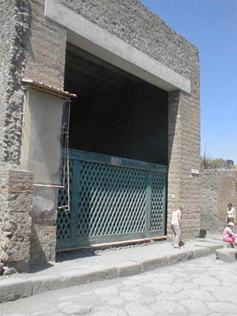 III.3.6 Pompeii. May 2005. 
Entrance, with reproduction of the original type of doorway gate.
The entrance doorway was almost as wide as the room behind it.  
It was thought this, full of military emblems, weapons, cupboards, etc, was occupied by a military association.
