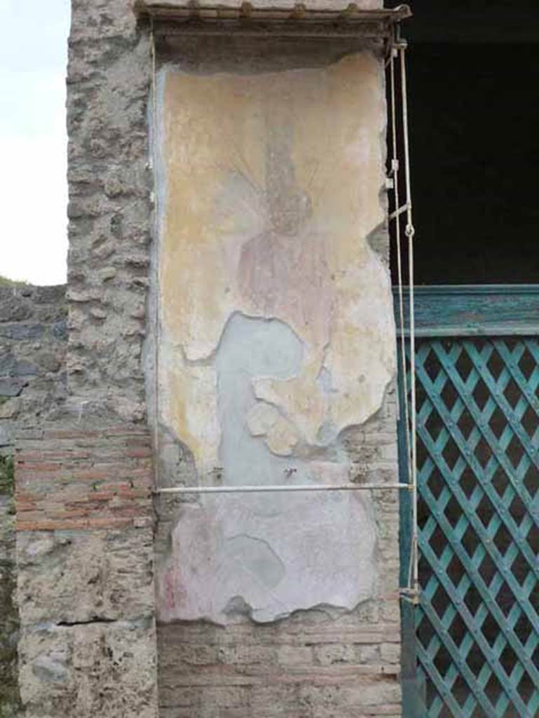 III.3.6 Pompeii. May 2010. Painted Roman trophy figure on west entrance pilaster. 