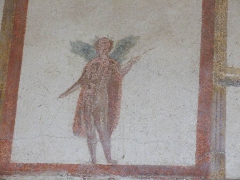 III.4.b Pompeii. March 2009. Room 4. Exedra.  Upper east wall. Painting of winged figure wearing a crown and holding a spear.