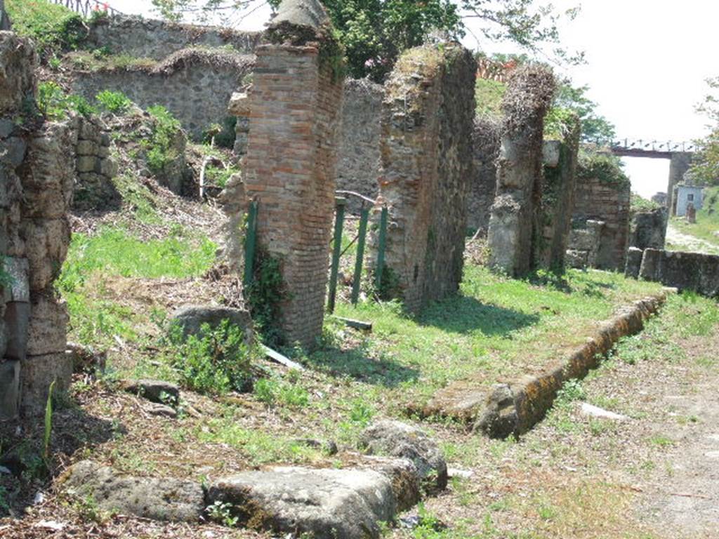 III.11.6 Pompeii. May 2006. Entrance with ramp. View along front of Insula III.11 on Via di Nola.