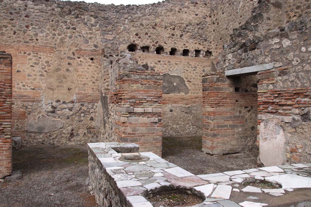 V.1.1 Pompeii. May 2003. Looking towards area of hearth on west side of counter. 
Photo courtesy of Nicolas Monteix.
