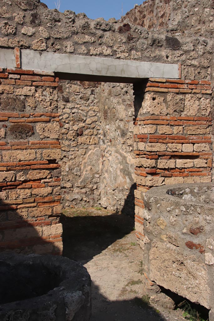 V.1.4 Pompeii. October 2023. 
Looking towards doorway to rear room in north-east corner of entrance room. Photo courtesy of Klaus Heese.

