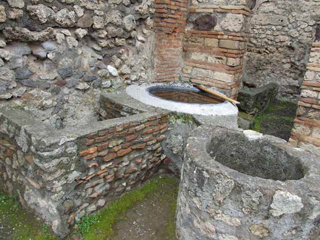 V.1.4 Pompeii. May 2010. West side of workshop, three water basins after restoration.