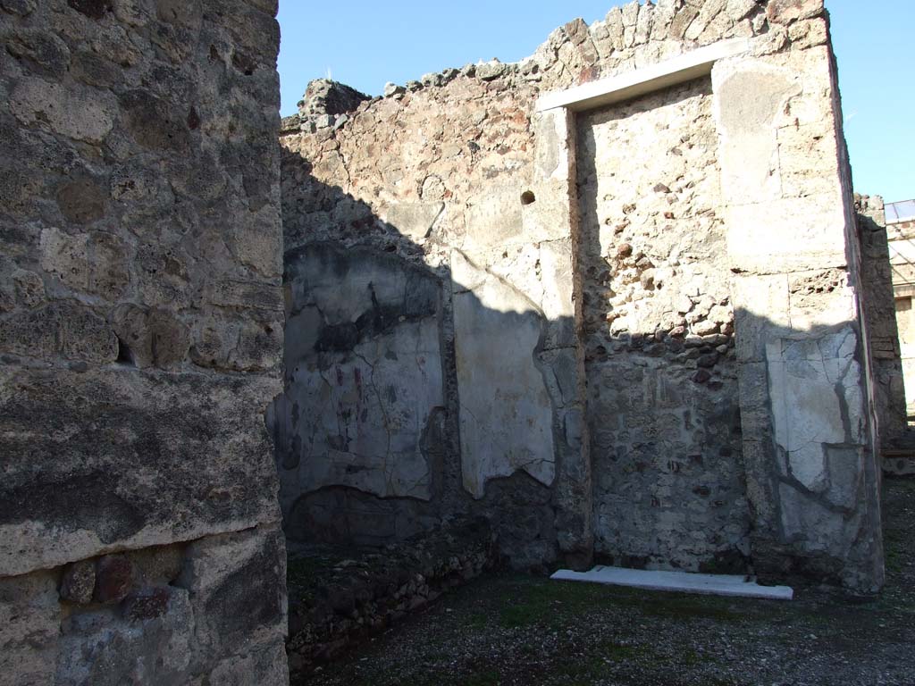 V.1.7 Pompeii. December 2007. 
Looking from atrium towards blocked doorway in north wall of atrium at side of room 7, the ala on west side. 
