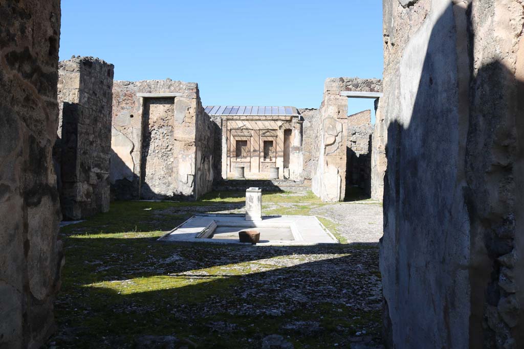 V.1.7, Pompeii. December 2018.  
Room 1, looking north from entrance corridor across impluvium in atrium. Photo courtesy of Aude Durand.
