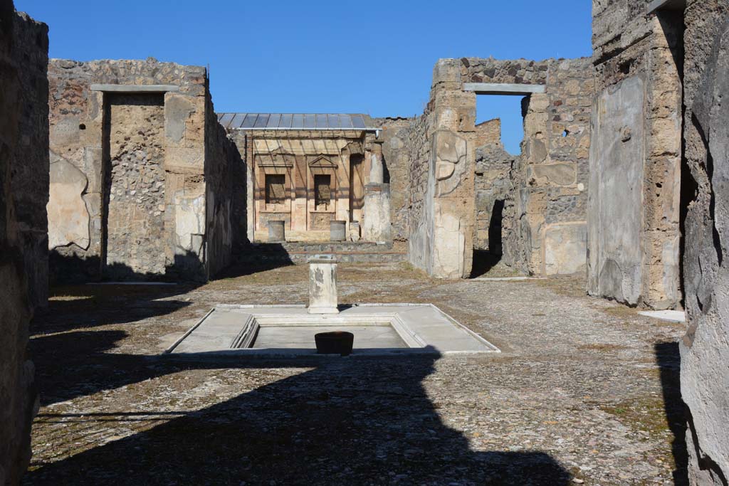 V.1.7, Pompeii. December 2018. 
Room 1, looking north across impluvium in atrium, from entrance corridor. Photo courtesy of Aude Durand.
