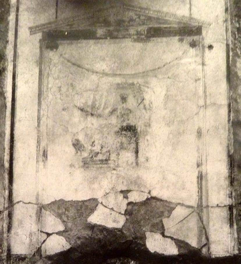 V.2.15 Pompeii. Old undated photograph. North wall of peristyle garden 11c. Remains of central painting in lararium.
Giove (Jupiter) sits on a throne, his lower body covered with a green robe. 
The sceptre is in the left hand, leaning on the arm of the throne. 
The lightning bolt is in his outstretched right hand and the eagle at his feet. 
See Notizie degli Scavi di Antichit, 1894, p. 439.
