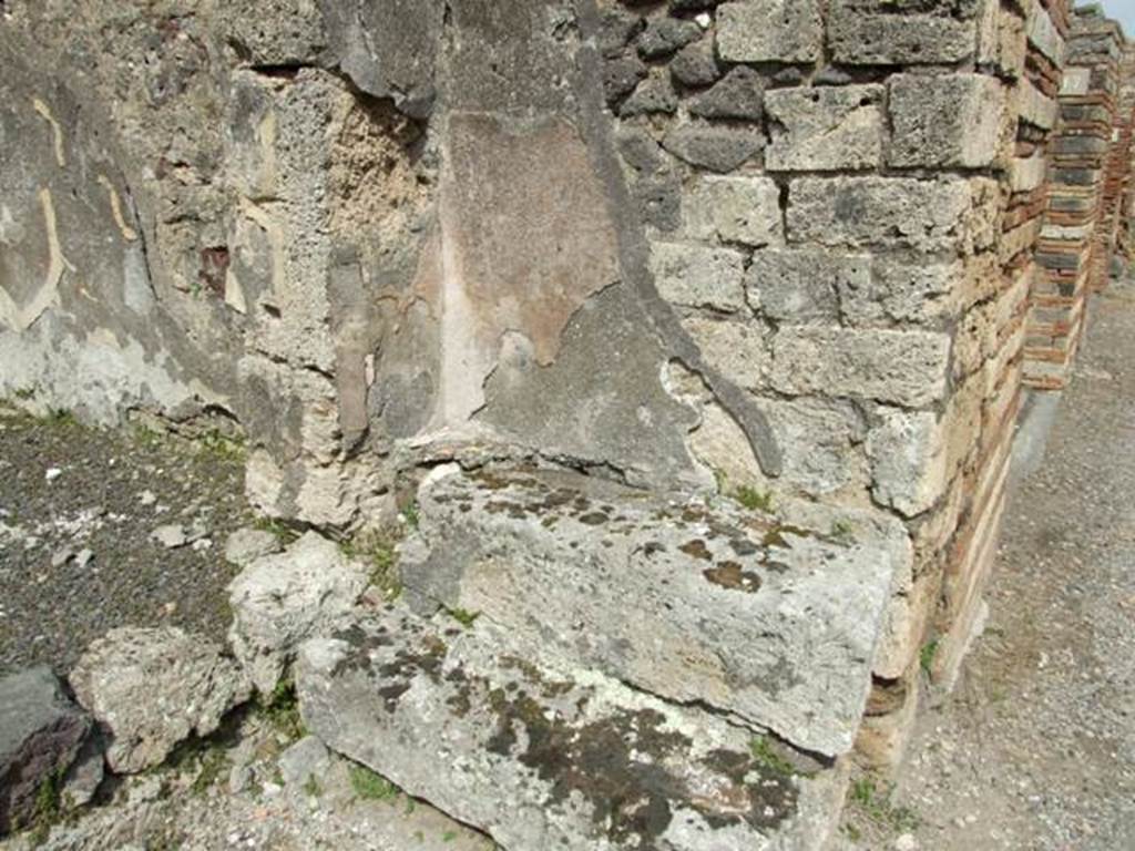 V.2.16 Pompeii.  March 2009. Two stone steps on east side of entrance doorway on Via di Nola, and wall at rear with plaster.