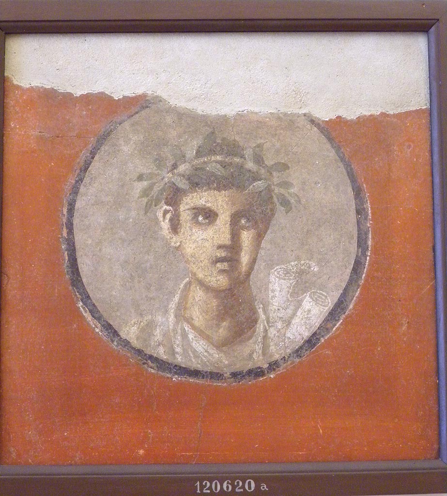 V.2.h Pompeii. 1892. Found in the tablinum, a portrait of male youth with crown.
The word HOMERVS was painted on the scroll. [CIL IV 3445]
Now in Naples Archaeological Museum. Inventory number 120620a.
See 13 gen 1892 NSA 1892, 28 V, ii, H, f.
Our thanks to Raffaele Prisciandaro for his help in identifying this object.
See Richardson, L., 2000. A Catalog of Identifiable Figure Painters of Ancient Pompeii, Herculaneum. Baltimore: John Hopkins. (p.102)
