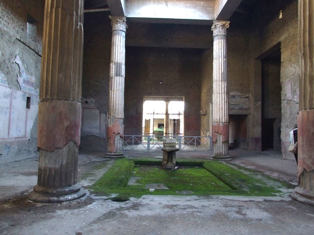 V.2.i Pompeii. August 2023. Room 1, atrium, south end of impluvium. 
Looking east towards stone basin on stand, rectangular marble base and travertine puteal. Photo courtesy of Johannes Eber.

