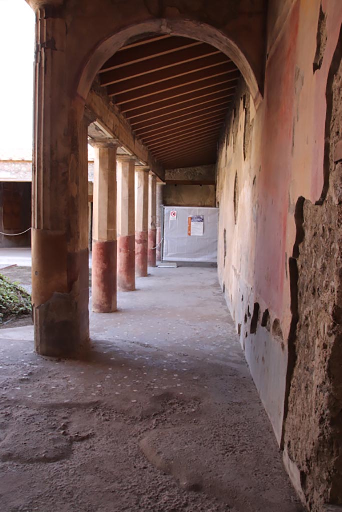 V.2.i Pompeii.  October 2023. 
Looking along west side of peristyle from south end of corridor 10. Photo courtesy of Klaus Heese.
