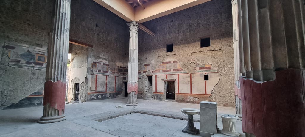 V.2.i Pompeii. March 2023. Room 1, atrium.
Looking north-east across impluvium with compluvium above. Photo courtesy of Johannes Eber.
