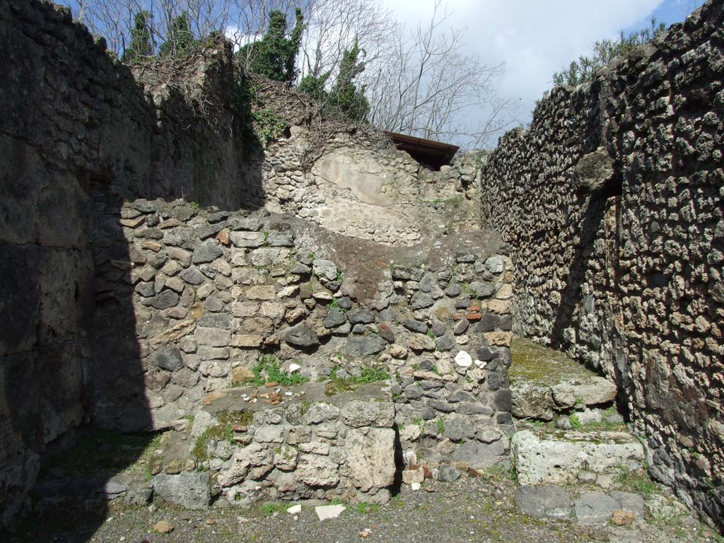 V.3.3 Pompeii. March 2009. North wall of shop with steps to upper floor, and another two steps to rear room.