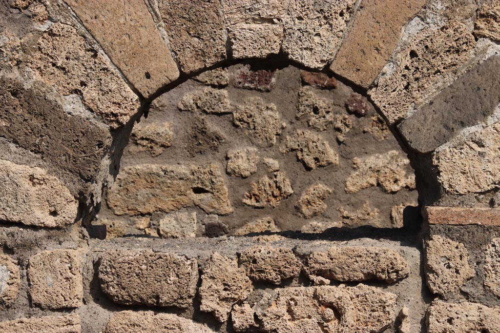 V.3.3 Pompeii. October 2023. East wall of shop-room, detail of blocked arched doorway. Photo courtesy of Klaus Heese.