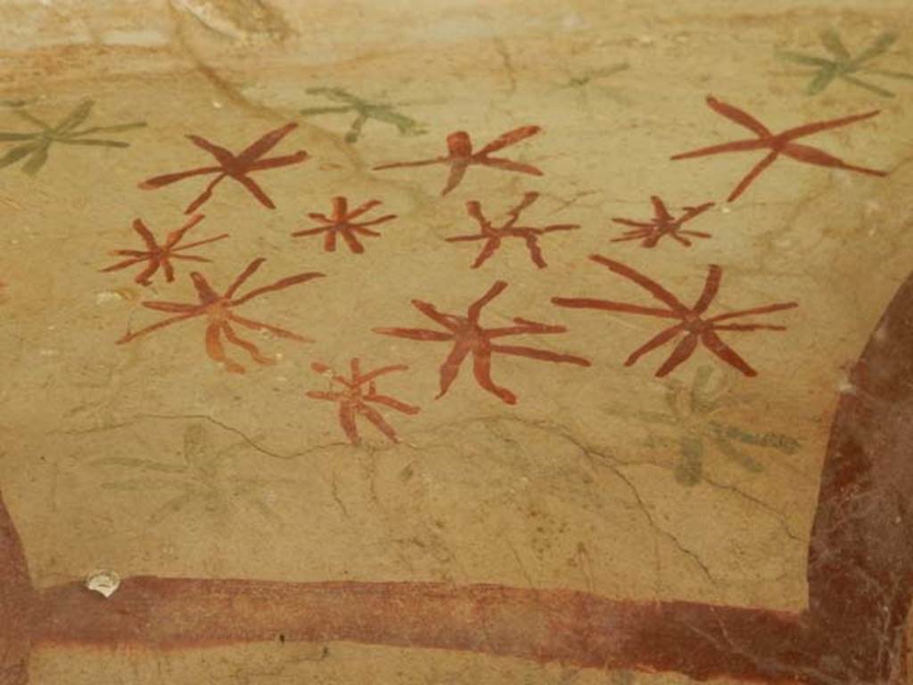 V.4.9 Pompeii. May 2017. Detail of painted red and green star-like ornaments on ceiling of lararium niche.  Photo courtesy of Buzz Ferebee.
