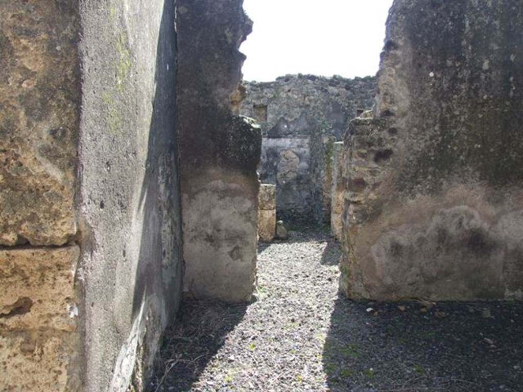 V.4.9 Pompeii.  March 2009.  South wall of large room, with doorway to a complex of three rooms.