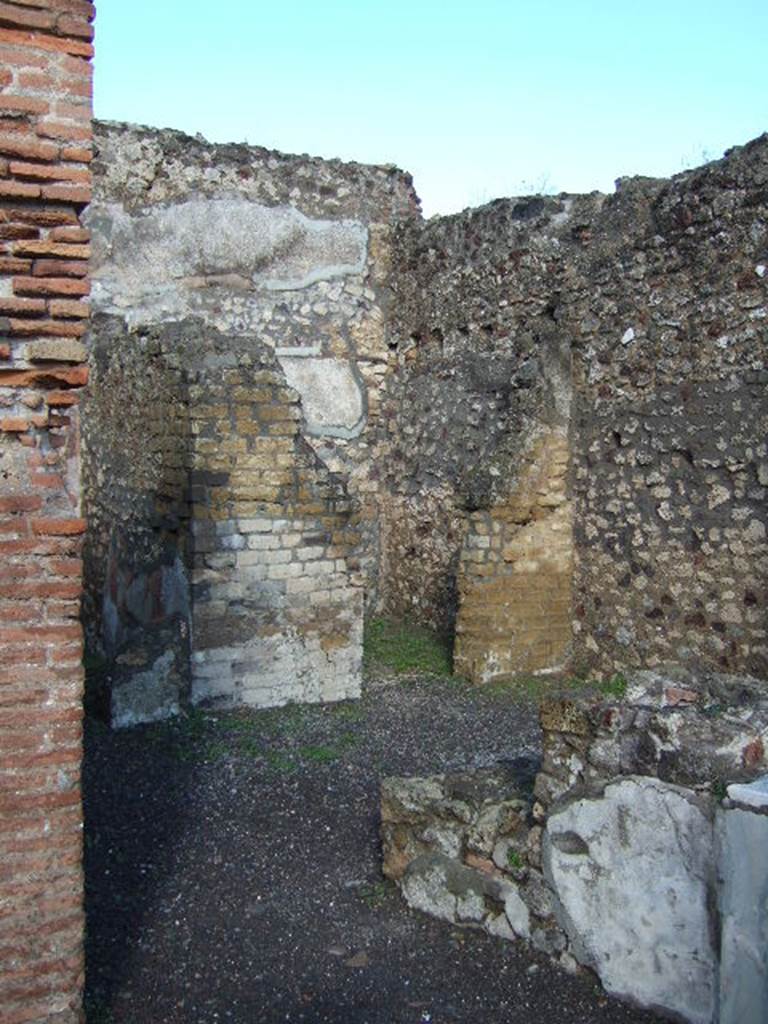 VI.3.20 Pompeii. December 2005. Looking across bar-room towards two doorways to rear rooms.