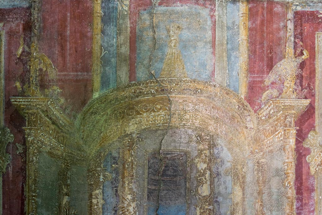 VI.7.23 Pompeii. October 2023. Detail of painted architectural detail from west wall of west alcove. Photo courtesy of Johannes Eber.