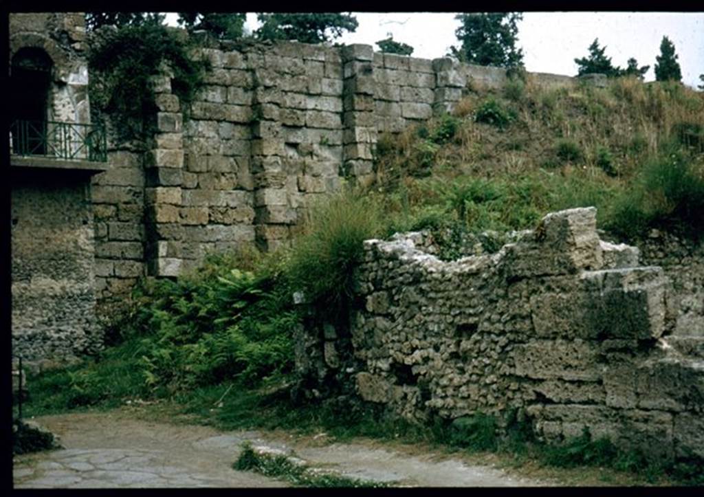 VI.9.1 Pompeii.    North west corner of exterior front wall on Via Mercurio, with Tower XI and City Walls.  Photographed 1970-79 by Günther Einhorn, picture courtesy of his son Ralf Einhorn.
