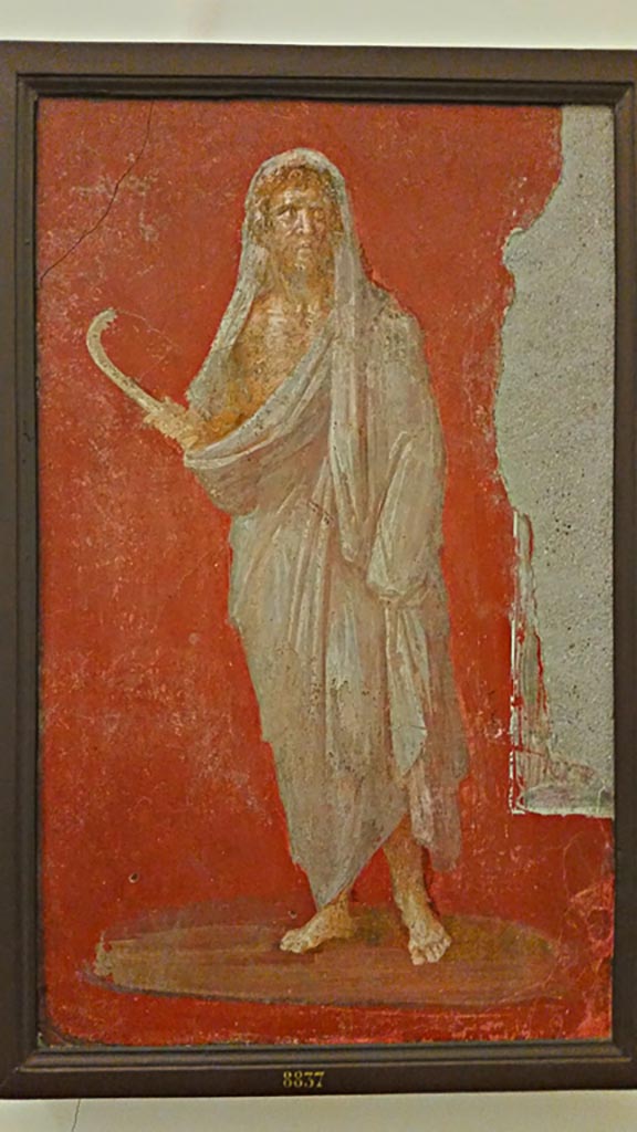 VI.9.6 Pompeii. Wall painting of Saturn or Chronos or Chronus holding a sickle.
One of two paintings that flanked the door in the deep bay of the atrium that formed a vestibule for the peristyle. 
Now in Naples Archaeological Museum. Inventory number 8837.
Photo courtesy of Giuseppe Ciaramella, November 2018.
