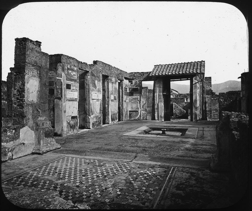 VI.12.2 Pompeii. Pre 1907 photo by George Washington Wilson. 
Looking south from tablinum towards the east side of atrium, as it was prior to the 1943 bombing.
Used with the permission of the Institute of Archaeology, University of Oxford. File name instarchbx208im 128. Source ID. 44453.
See photo on University of Oxford HEIR database
