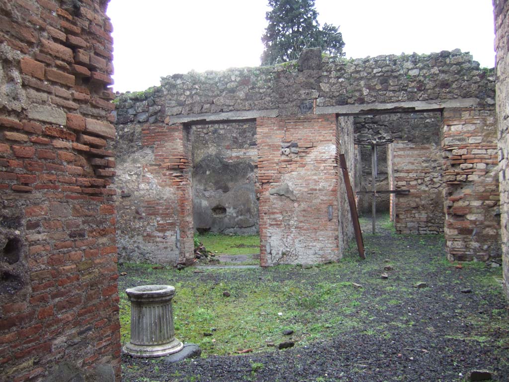 VI.13.16 Pompeii. December 2005. Two doorways on west side of atrium.
On the left is the doorway to the large room with a window, in the centre is the doorway to the room communicating with the garden area.
