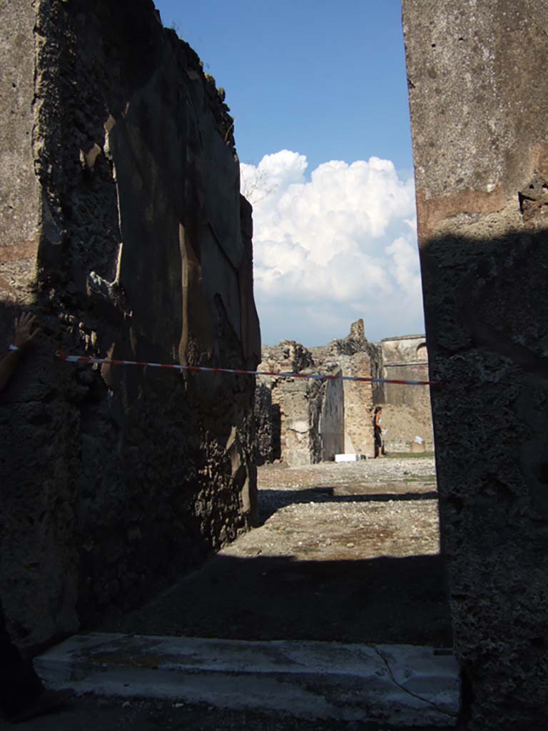 VI.13.19 Pompeii. September 2005. Entrance doorway, looking east.
A graffito was found inscribed to the left of the entrance 
Hectice pupe va(le) Mercator tibi dicit    [CIL IV 4485]

This translates as:
Hecticus, my pet, Mercator says hello to you.  [CIL IV 4485]
Varone says Mercator could either have been a name or meant “the merchant”.
See Varone, A., 2002. Erotica Pompeiana: Love Inscriptions on the Walls of Pompeii, Rome: L’erma di Bretschneider. (p.133)

Another graffito found inscribed near the doorway was

Daphnicus  cum  Felicula  sua  hac  
Bene  Felicule,  bene  Daphnico
Utriusque  bene  eveniat      [CIL IV 4477]

This translates as:
Daphnicus and his Felicula were here.
Long live Felicula. Long live Daphnicus.
All the best to both of them   [CIL IV 4477]

According to Varone, the same couple were also mentioned near the doorway of V.1.18, [CIL IV 4066]
See Varone, A., 2002. Erotica Pompeiana: Love Inscriptions on the Walls of Pompeii, Rome: L’erma di Bretschneider. (p.163)

According to Della Corte, a seal/signet was found with the name (Sex.) Pompeius Axiochus  [CIL X 8058,68]  (S 72, with note 3 on p.62) 
Della Corte also thought it very probable that the wife of the owner’s name was Julia Helena, because in this same house were found two wine amphorae.
These were addressed to her with the names -  Iuliae Helenae  [CIL IV 5851]
See Della Corte, M., 1965. Case ed Abitanti di Pompei. Napoli: Fausto Fiorentino. (p.62)

According to Epigraphik-Datenbank Clauss/Slaby (See www.manfredclauss.de), these read as –

Iuliae Helenae
Iuliae Helenae      [CIL IV 5851]

Pompei
Axiochi                  [CIL X 8058,68]

