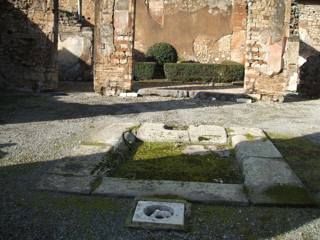 VI.14.12 Pompeii. December 2004. North side of atrium and garden area.
According to Jashemski, the garden at the rear of the house was excavated in 1874, without a tablinum.
There was a portico on the south and east sides, supported by two columns.
The two rooms on the west and east sides of the garden, each had a window overlooking it.
See Jashemski, W. F., 1993. The Gardens of Pompeii, Volume II: Appendices. New York: Caratzas. (p.149)
