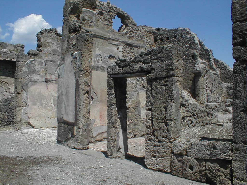VI.14.12 Pompeii. December 2004. Two doorways to cubicula on east side of atrium.