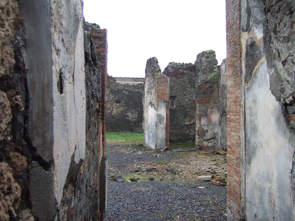 VI.14.42 Pompeii. December 2005. Looking from entrance corridor towards south wall of tablinum, and doorway to cubiculum on its south side.