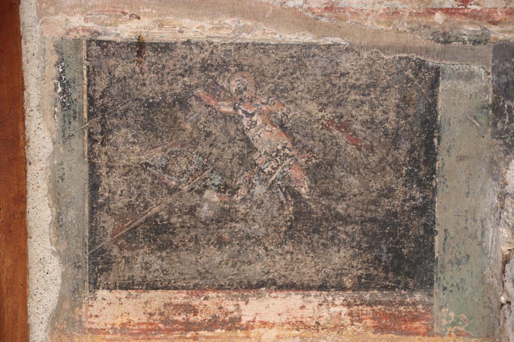 VI.15.1 Pompeii. October 2023. 
Detail from north wall of atrium, painted decoration from west side of masonry base for strongbox.
Photo courtesy of Klaus Heese.
