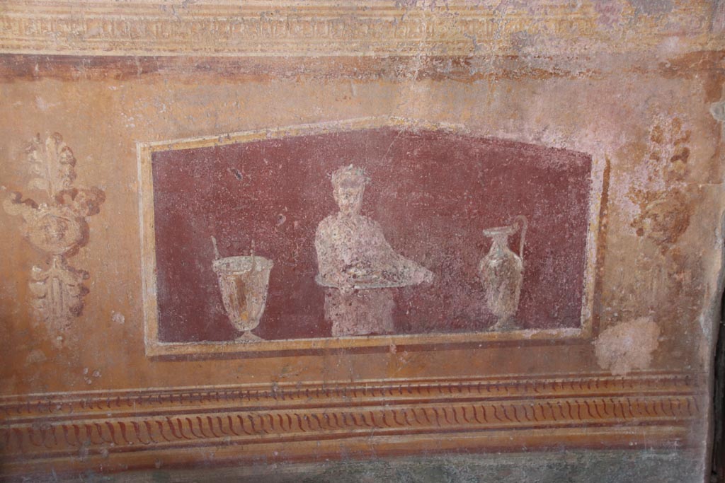 VI.15.1 Pompeii. October 2023. 
North side of atrium, detail of painted panel on lower east side of masonry base for strongbox. Photo courtesy of Klaus Heese.

